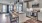 Three Bedroom Apartments in Grand Prairie, TX - Jefferson Cove - Modern Kitchen with Stainless Steel Appliances, a Kitchen Island, Light Grey Cabinetry, White Tile Backsplash, Granite Countertops, and Wood Plank Flooring